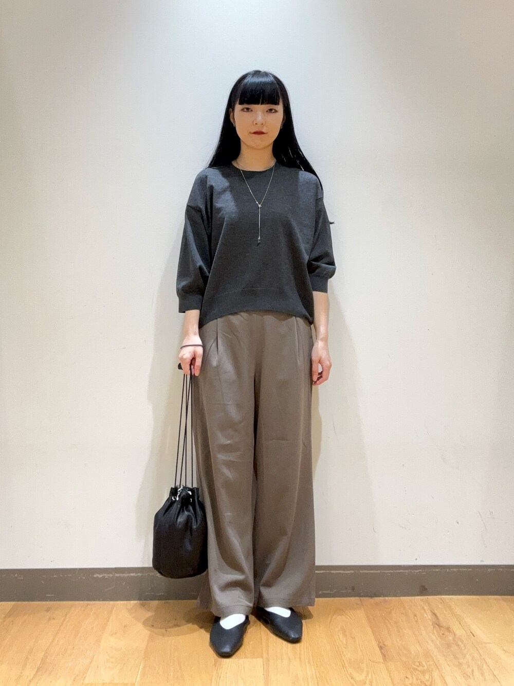 グレー系のその他トップス、ベージュ系のその他パンツ、ブラック系のショルダーバッグを着用したレディースの秋コーディネートの1枚目の写真