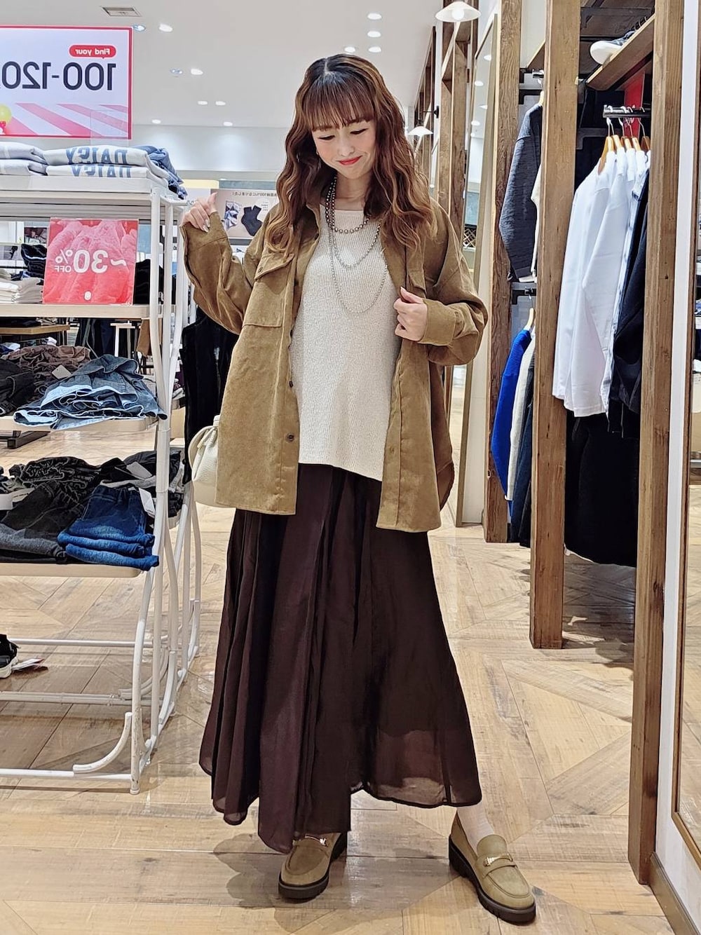 イエロー系のシャツ/ブラウス、ブラウン系のスカート、ベージュ系のローファーを着用したレディースの秋コーディネートの1枚目の写真