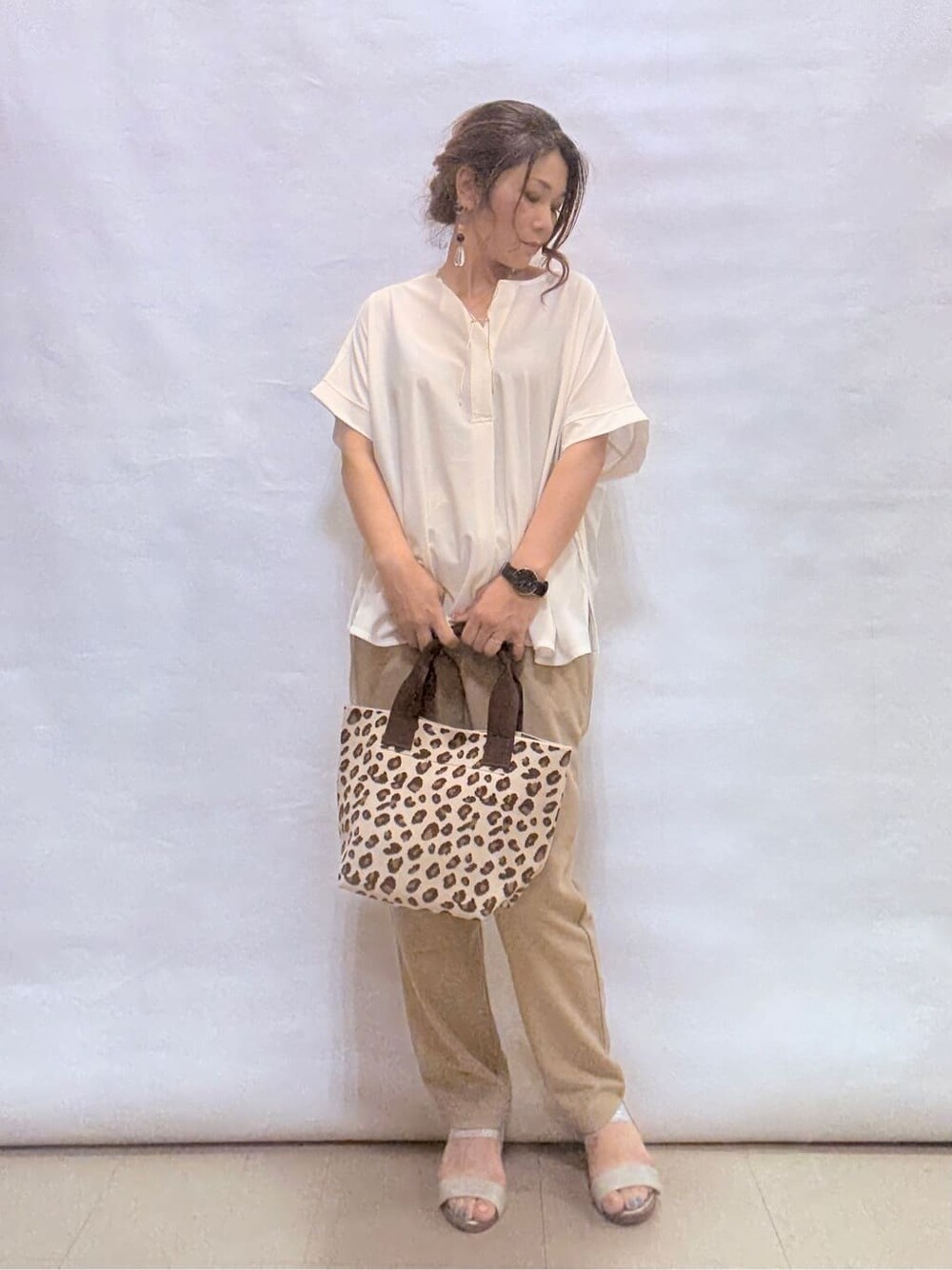 ホワイト系のTシャツ/カットソー、ベージュ系のその他パンツ、シルバー系のサンダルを着用したレディースの夏コーディネートの1枚目の写真
