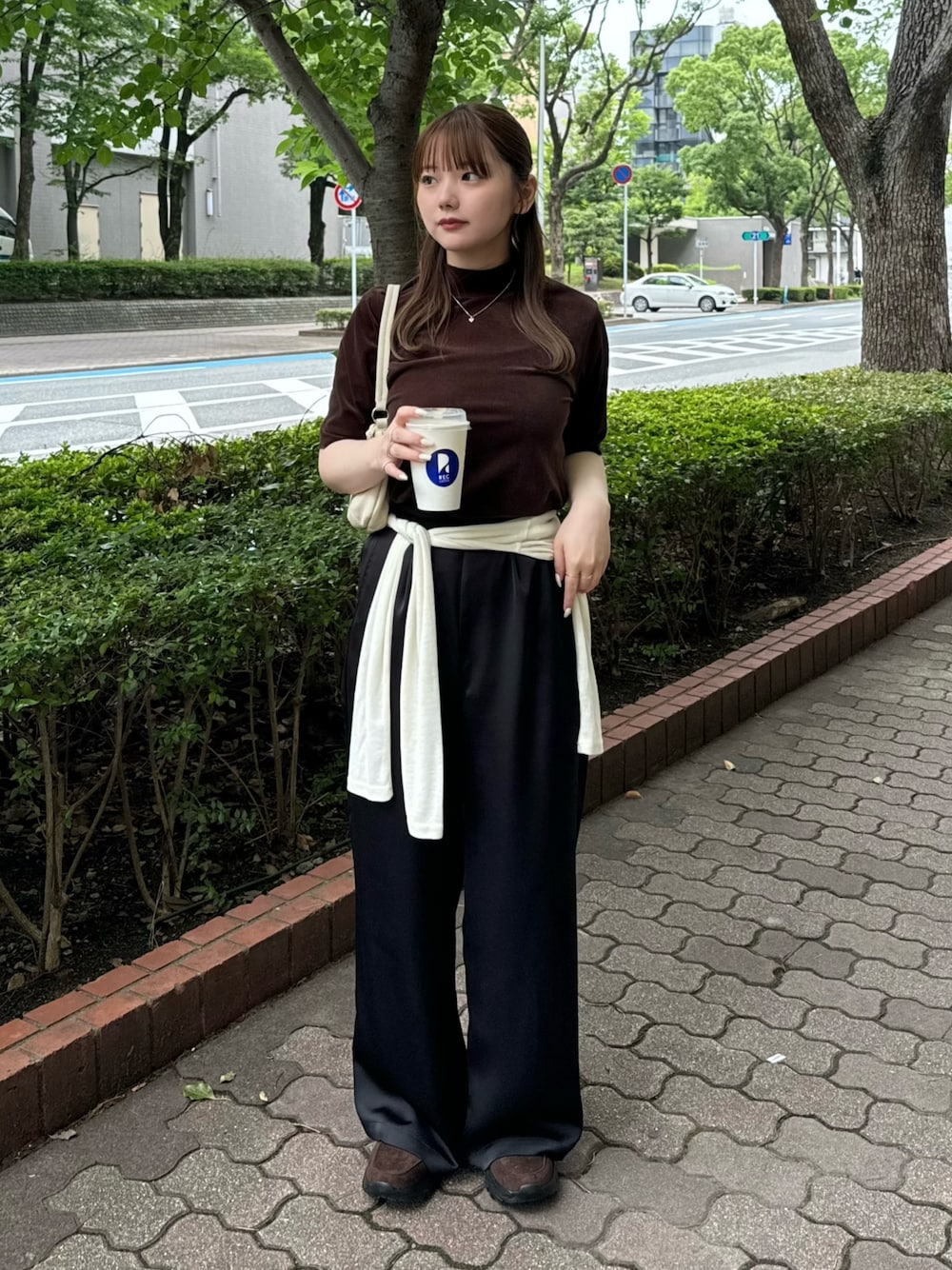 ブラウン系のTシャツ/カットソー、ホワイト系のハンドバッグ、ベージュ系のTシャツ/カットソーを着用したレディースの夏コーディネートの1枚目の写真