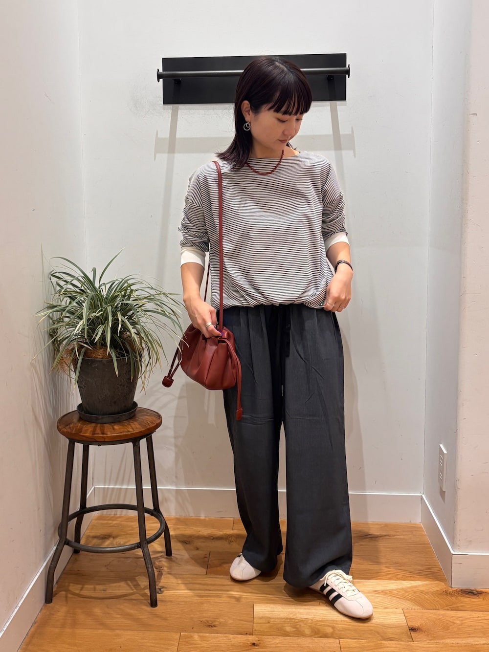 ホワイト系のTシャツ/カットソー、グレー系のその他パンツ、レッド系のショルダーバッグを着用したレディースの秋コーディネートの1枚目の写真