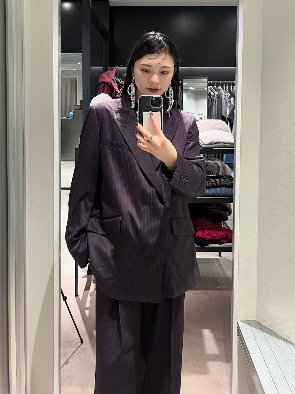 シルバー系のブーツ、ブラック系のシャツ/ブラウス、パープル系のスラックスを着用したレディースの秋コーディネートの1枚目の写真