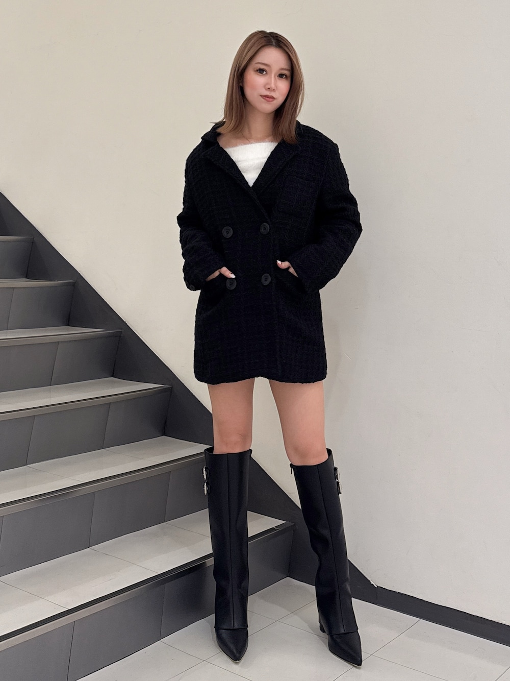 ブラック系のテーラードジャケット、ブラック系のブーツを着用したレディースの秋コーディネートの1枚目の写真