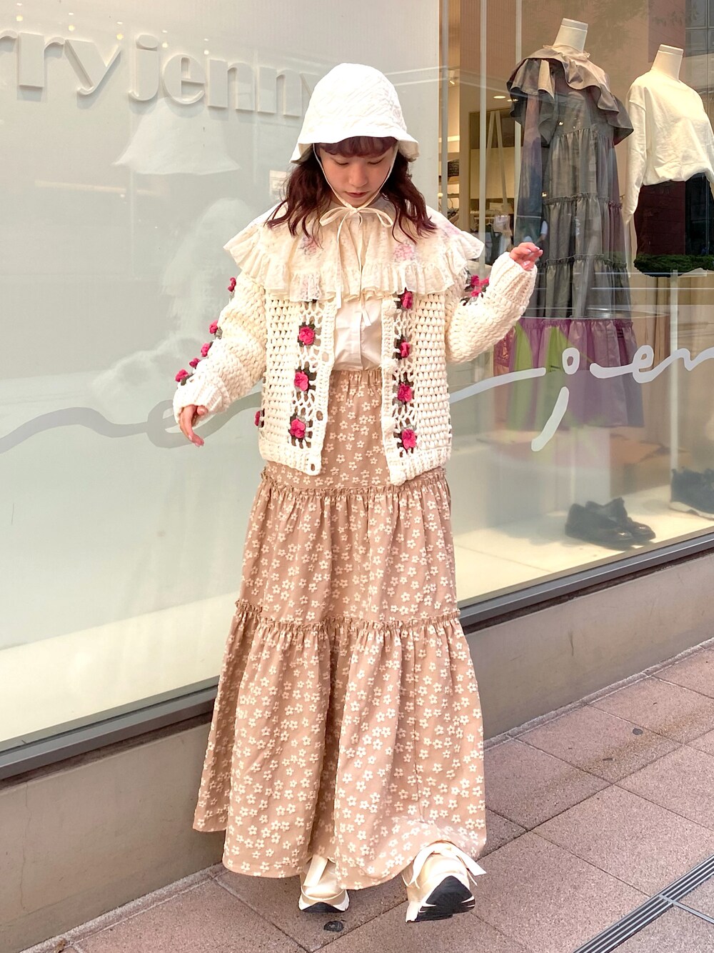 ホワイト系のカーディガン/ボレロ、ホワイト系のシャツ/ブラウス、ベージュ系のスカートを着用したレディースの秋コーディネートの1枚目の写真