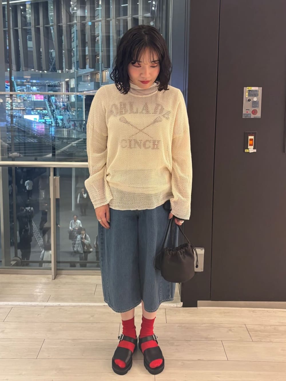 ブラック系のサンダル、ホワイト系のニット/セーター、ブルー系のデニムパンツを着用したレディースの夏コーディネートの1枚目の写真