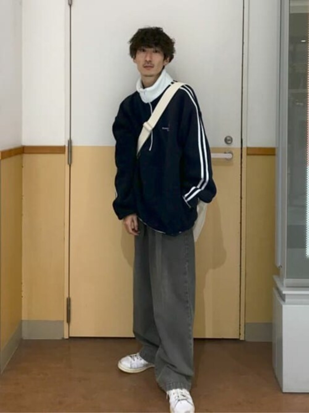 ブルー系のスウェット、イエロー系のデニムパンツを着用したメンズの秋コーディネートの1枚目の写真