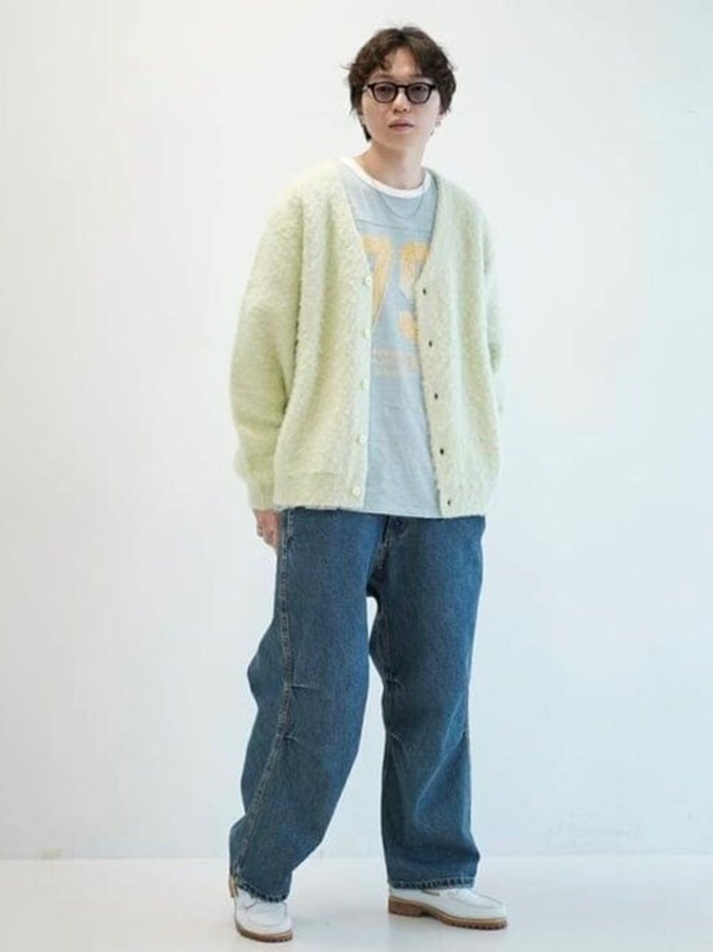 グリーン系のカーディガン/ボレロ、ブルー系のデニムパンツ、ブルー系のTシャツ/カットソーを着用したメンズの秋コーディネートの1枚目の写真