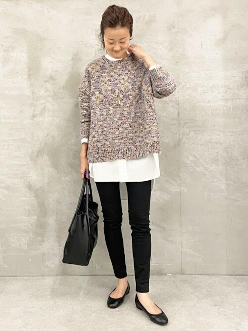 ブルー系のニット/セーター、ホワイト系のシャツ/ブラウス、ブラック系のトートバッグを着用したレディースの秋コーディネートの1枚目の写真