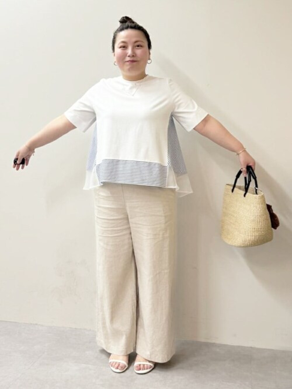 ホワイト系のTシャツ/カットソー、ベージュ系のその他パンツ、ベージュ系のかごバッグを着用したレディースの春コーディネートの1枚目の写真