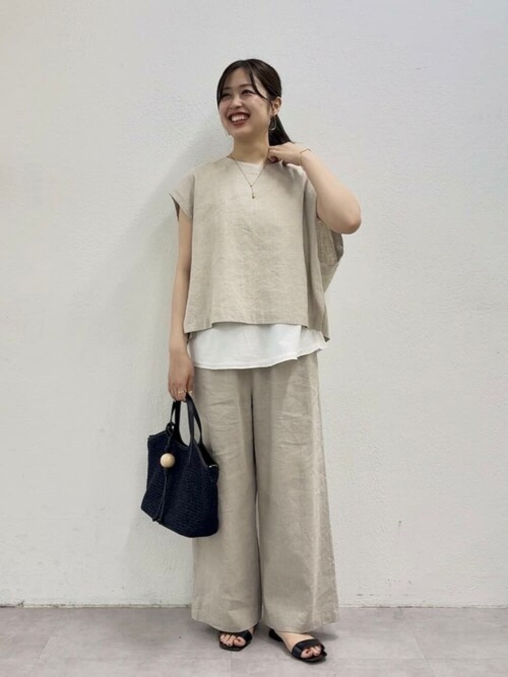 ベージュ系のシャツ/ブラウス、ホワイト系のタンクトップ、ベージュ系のその他パンツを着用したレディースの春コーディネートの1枚目の写真