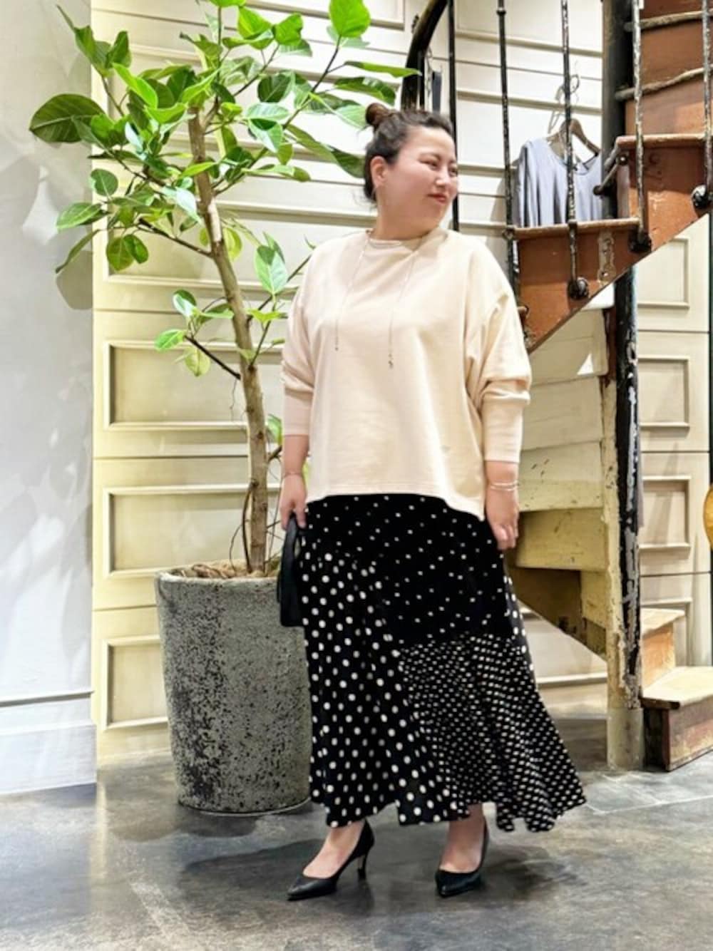 ピンク系のTシャツ/カットソー、ブラック系のスカート、ゴールド系のネックレスを着用したレディースの夏コーディネートの1枚目の写真