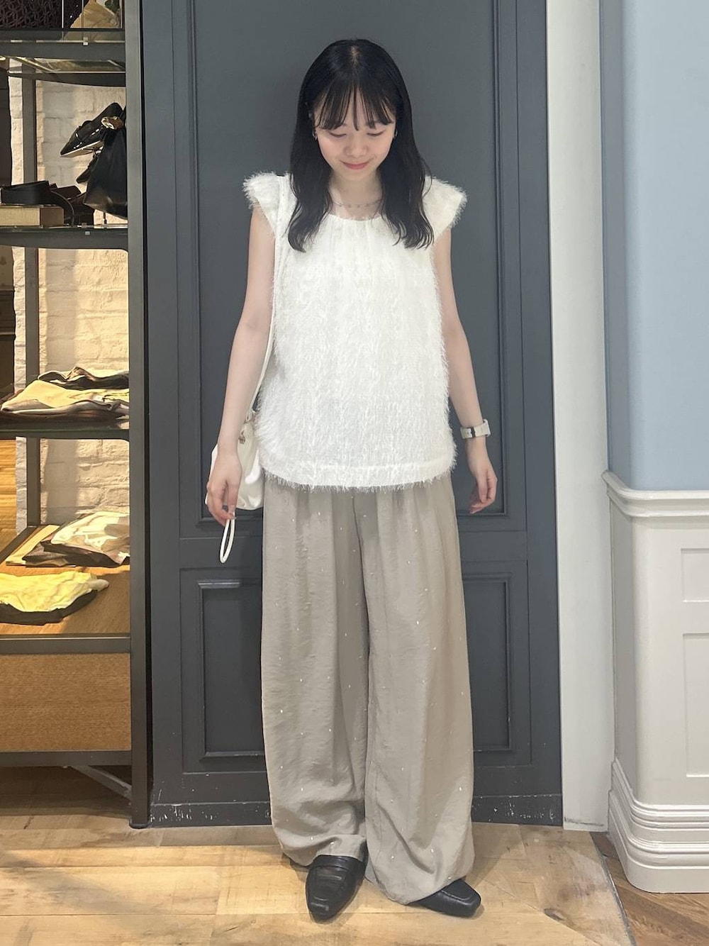 ホワイト系のショルダーバッグ、ホワイト系のシャツ/ブラウス、ベージュ系のその他パンツを着用したレディースの夏コーディネートの1枚目の写真