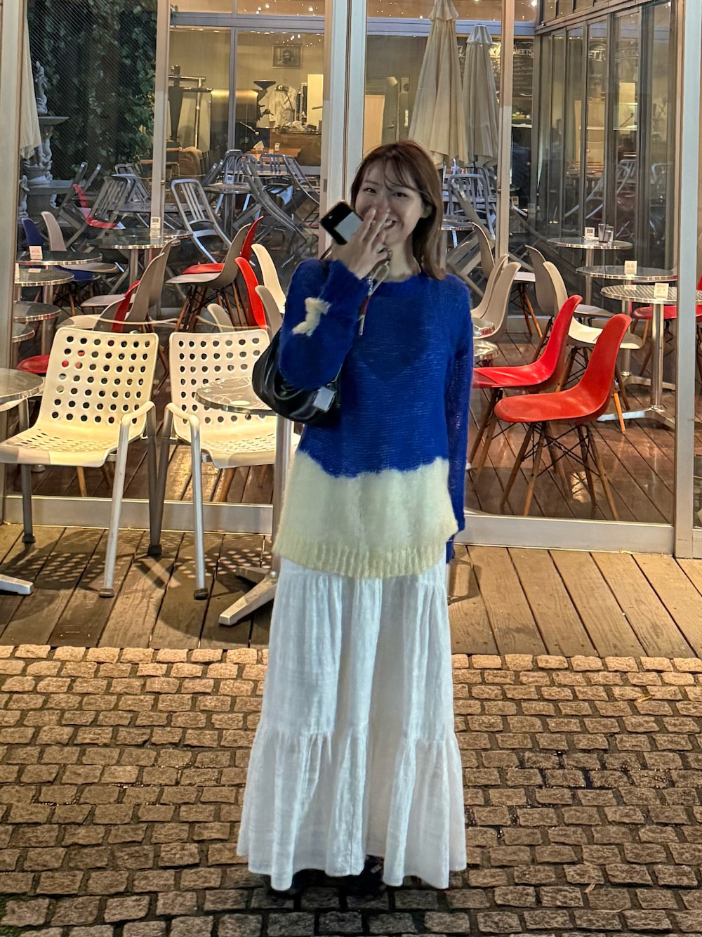 ブルー系のニット/セーター、ホワイト系のワンピースを着用したレディースの秋コーディネートの1枚目の写真