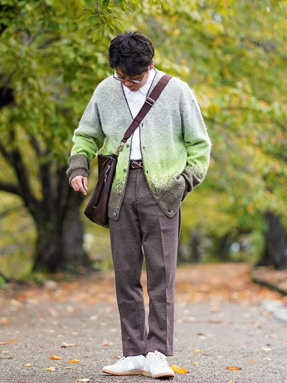 グリーン系のカーディガン/ボレロ、ホワイト系のシャツ/ブラウス、ブラウン系のパンツを着用したメンズの秋コーディネートの1枚目の写真