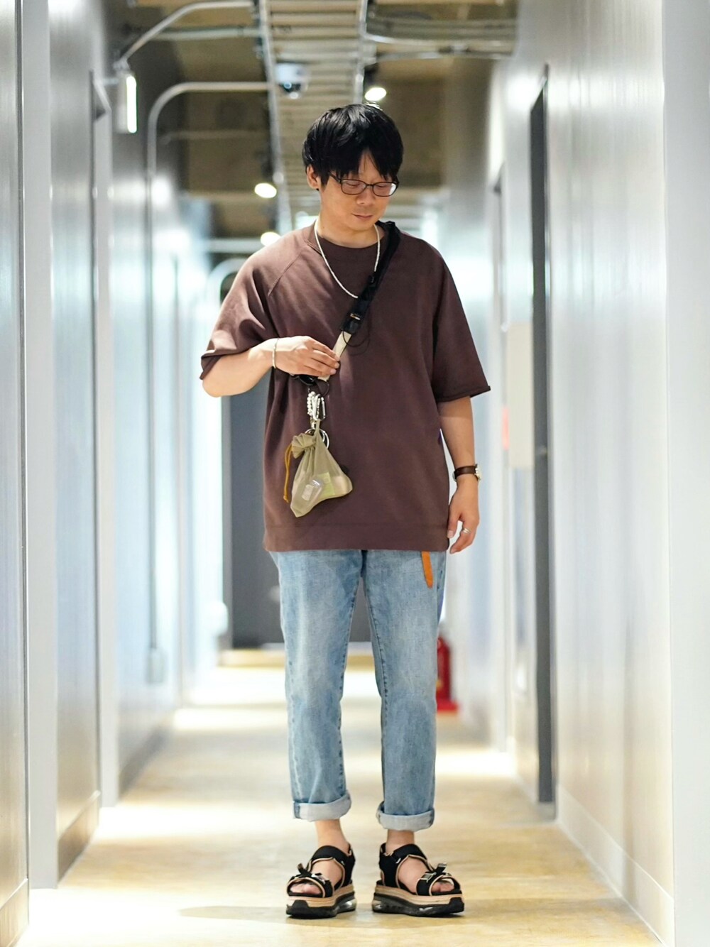 ブラウン系のTシャツ/カットソー、ブルー系のデニムパンツ、ブラック系のサンダルを着用したメンズの夏コーディネートの1枚目の写真