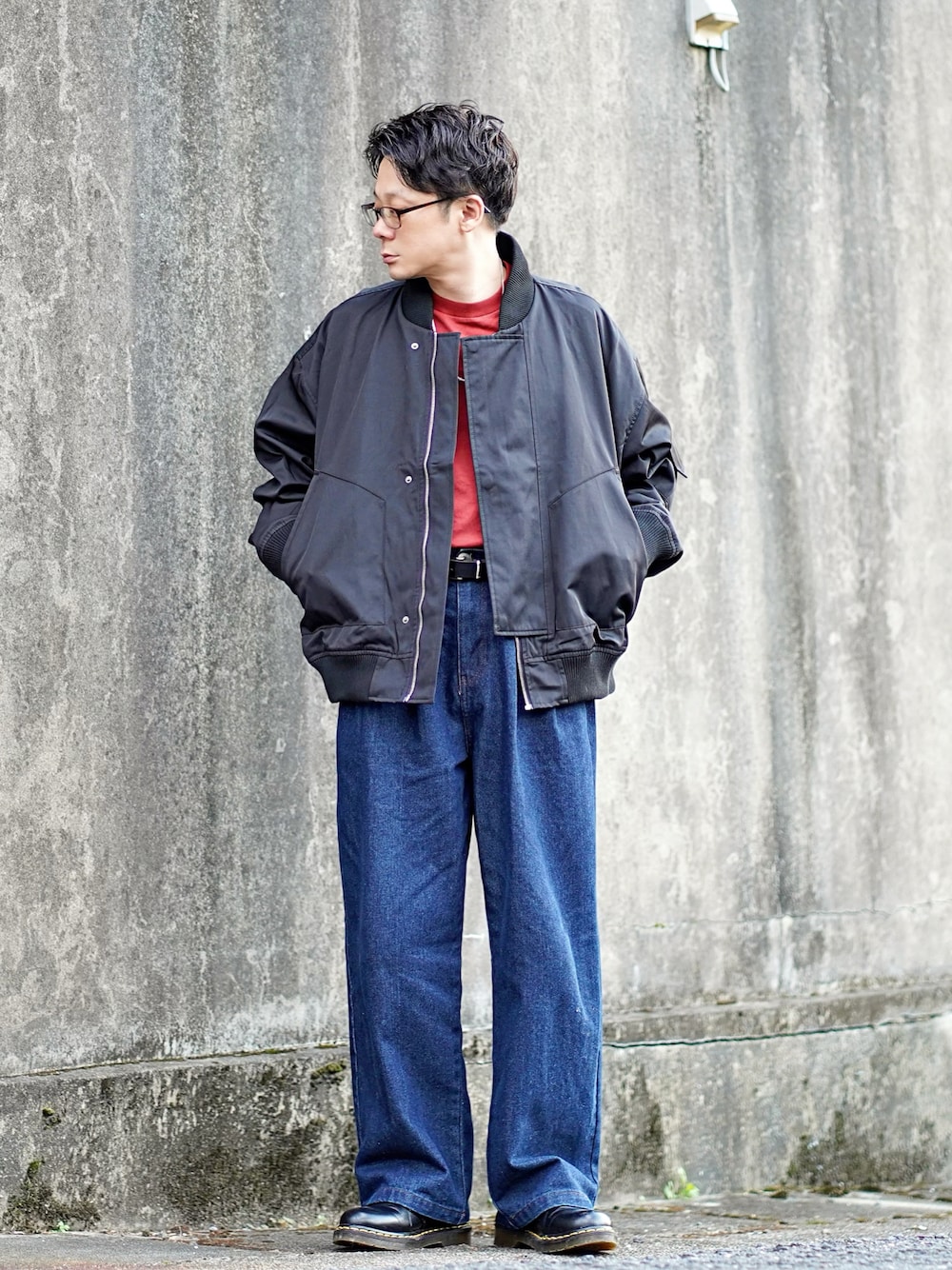 ブラック系のMA-1、レッド系のTシャツ/カットソー、ブルー系のデニムパンツを着用したメンズの秋コーディネートの1枚目の写真
