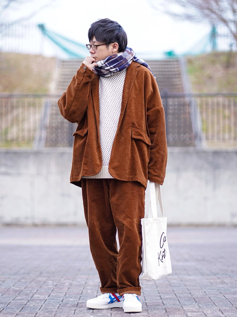 ホワイト系のニット/セーター、ブラウン系のテーラードジャケット、ブラウン系のその他パンツを着用したメンズの冬コーディネートの1枚目の写真