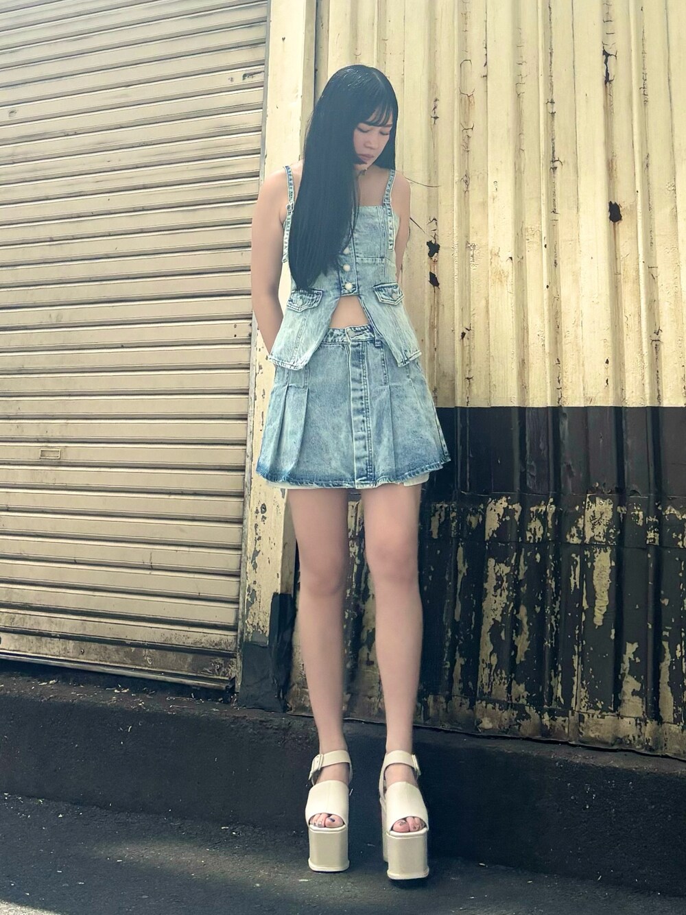 ブルー系のキャミソール、ブルー系のデニムスカート、ホワイト系のサンダルを着用したレディースの夏コーディネートの1枚目の写真