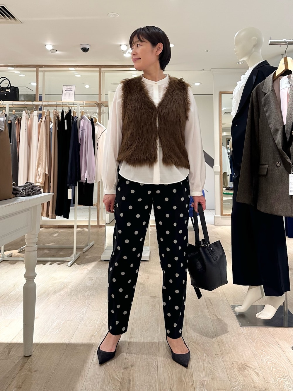 ブラック系のその他パンツ、ブラック系のショルダーバッグ、ホワイト系のシャツ/ブラウスを着用したレディースの秋コーディネートの1枚目の写真