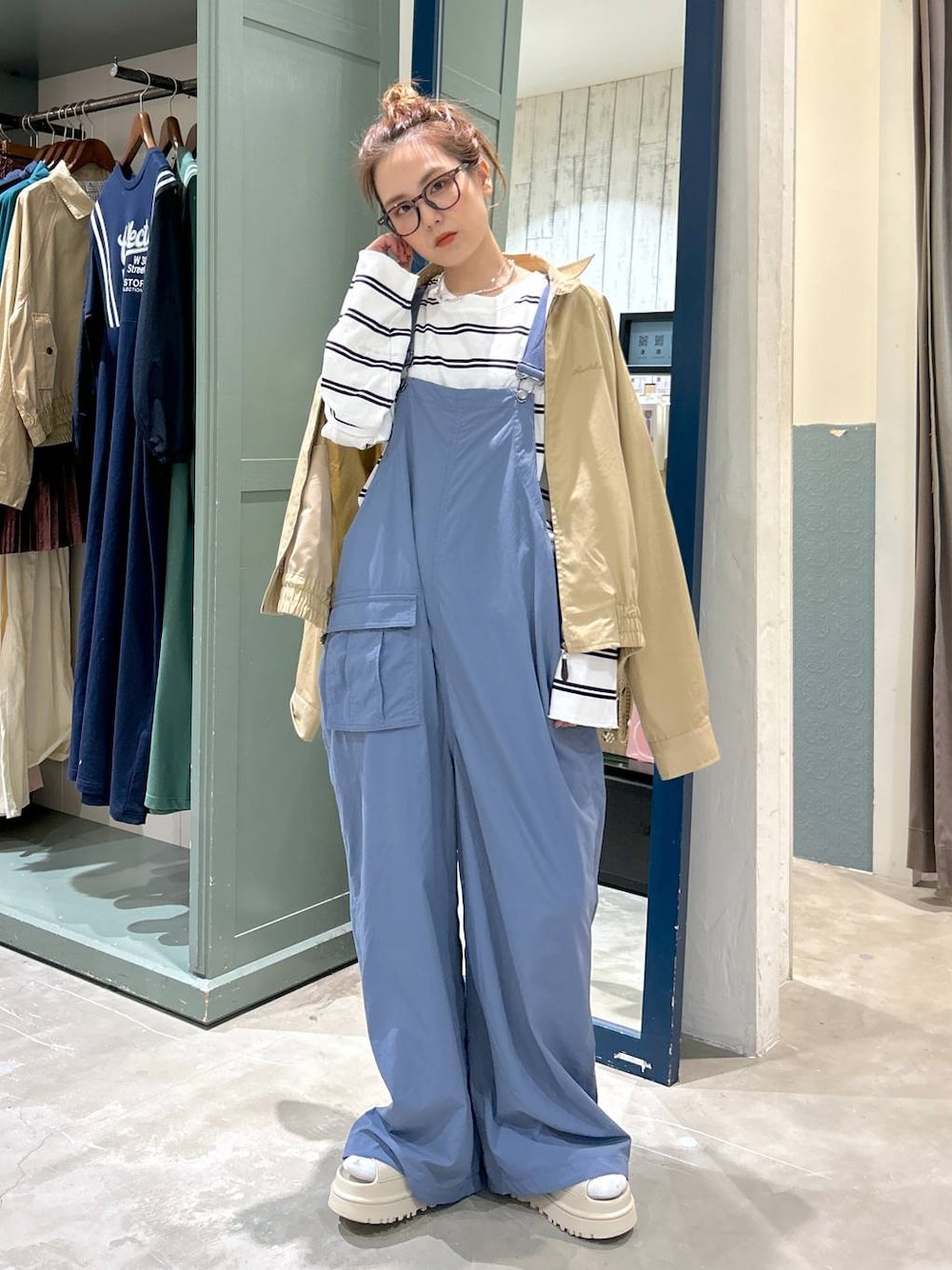 ベージュ系のブルゾン、ホワイト系のTシャツ/カットソー、ブルー系のサロペット/オーバーオールを着用したレディースの春コーディネートの1枚目の写真