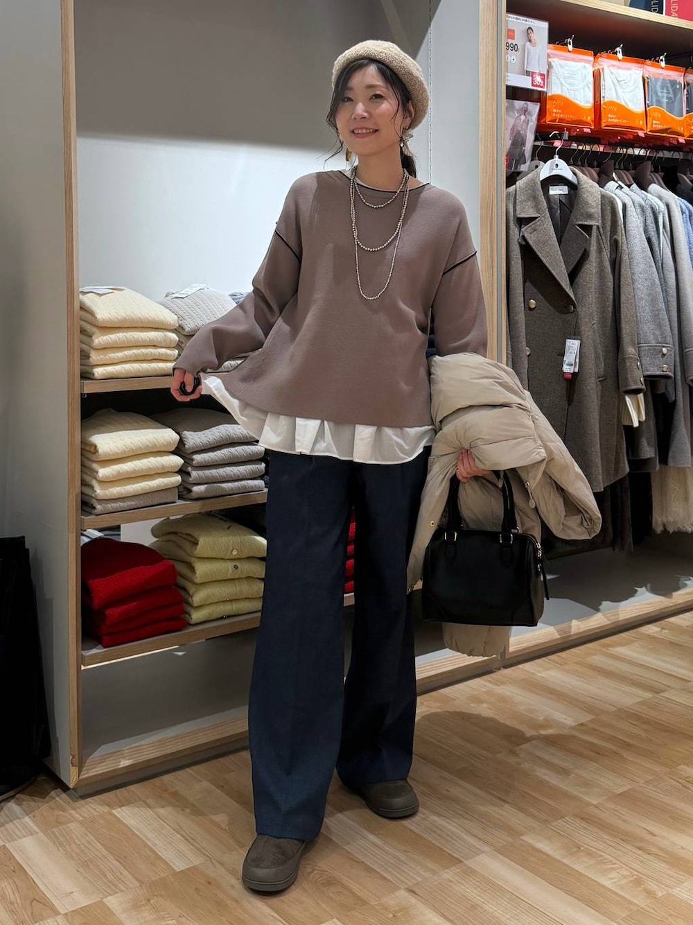 ベージュ系のダウンジャケット/コート、ブルー系のその他パンツ、ホワイト系のTシャツ/カットソーを着用したレディースの春コーディネートの1枚目の写真