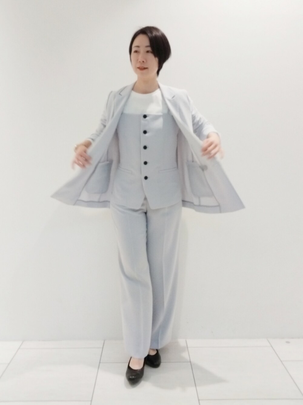 ホワイト系のTシャツ/カットソー、グレー系のタンクトップ、グレー系のスーツジャケットを着用したレディースの春コーディネートの1枚目の写真