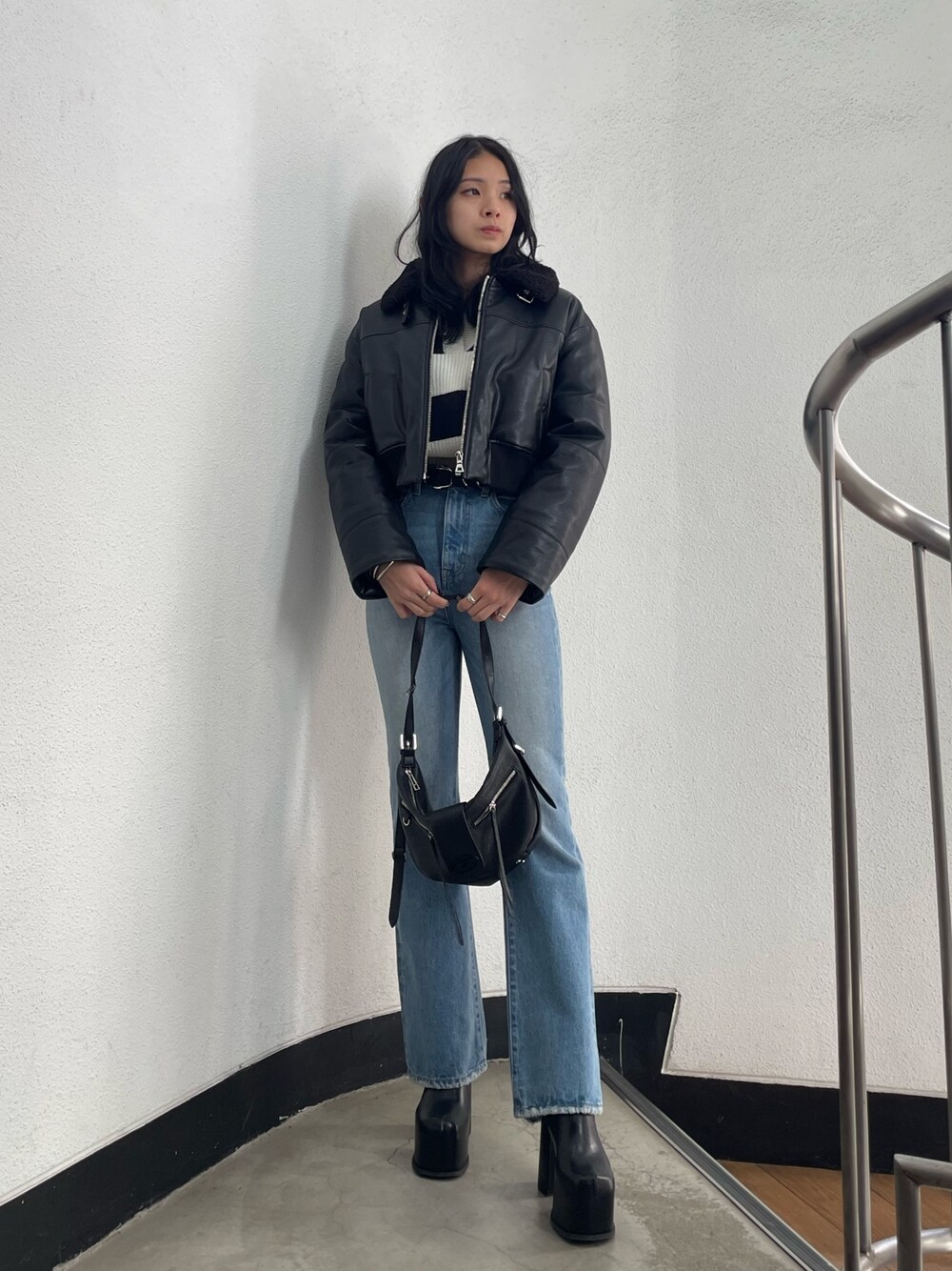 ブラック系のブルゾン、その他のニット/セーター、ブルー系のデニムパンツを着用したレディースの冬コーディネートの1枚目の写真