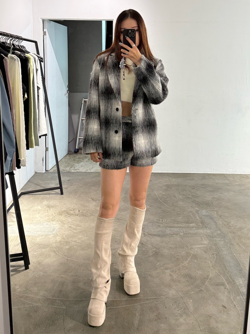 ホワイト系のニット/セーター、ブラック系のその他アウター、ブラック系のその他パンツを着用したレディースの冬コーディネートの1枚目の写真