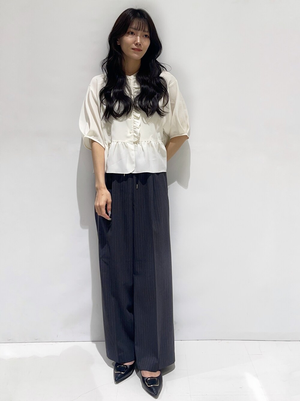 ホワイト系のシャツ/ブラウス、グレー系のその他パンツ、ブラック系のパンプスを着用したレディースの秋コーディネートの1枚目の写真