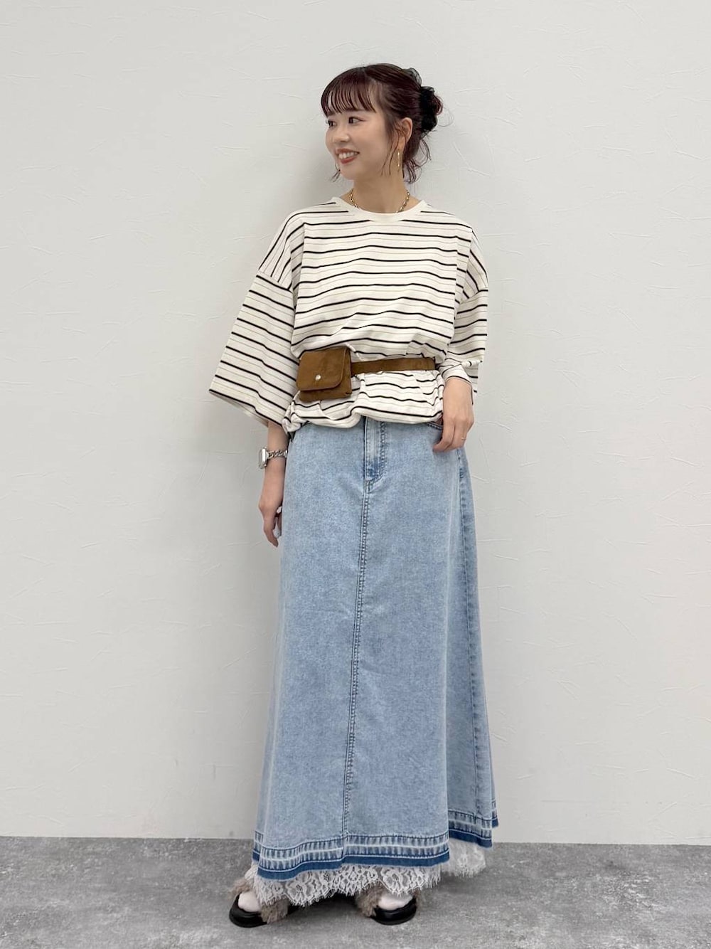 ブルー系のデニムスカート、ホワイト系のTシャツ/カットソー、イエロー系のベルトを着用したレディースの夏コーディネートの1枚目の写真