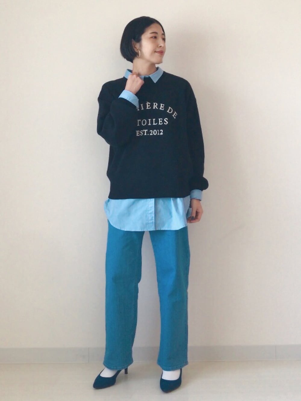 ブラック系のニット/セーター、ブルー系のシャツ/ブラウス、ブルー系のデニムパンツを着用したレディースの冬コーディネートの1枚目の写真