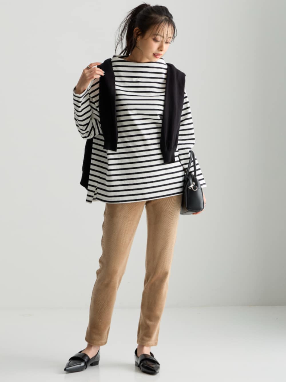 ブラック系のカーディガン/ボレロ、シルバー系のTシャツ/カットソー、ブラック系のパンツを着用したレディースの秋コーディネートの1枚目の写真