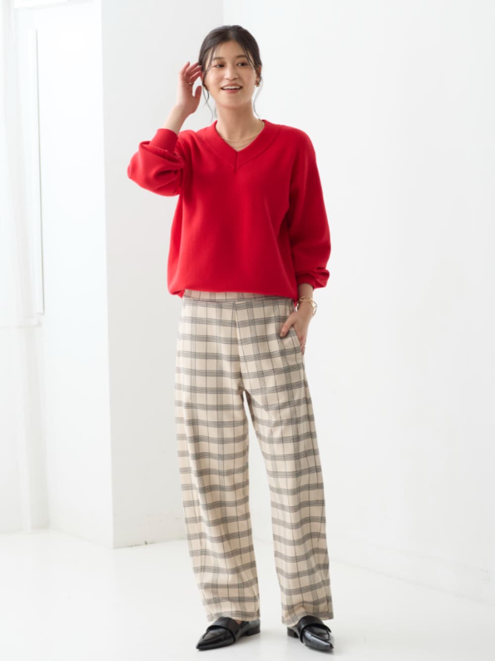 ブルー系のパンツ、レッド系のニット/セーターを着用したレディースの秋コーディネートの1枚目の写真