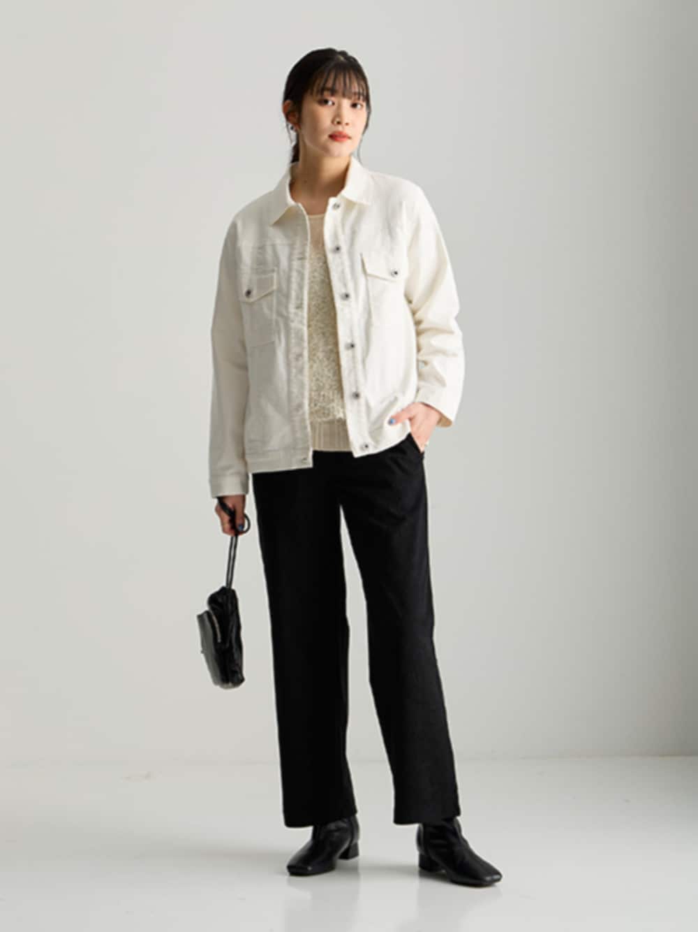 ホワイト系のジャケット/アウター、ブラック系のパンツを着用したレディースの秋コーディネートの1枚目の写真