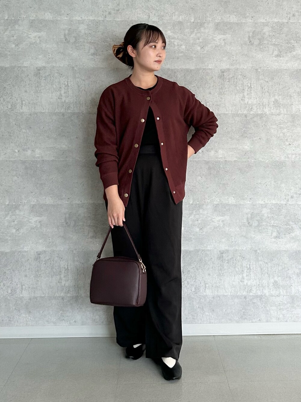 レッド系のショルダーバッグ、ブラック系のその他パンツ、ブラック系のパンプスを着用したレディースの秋コーディネートの1枚目の写真