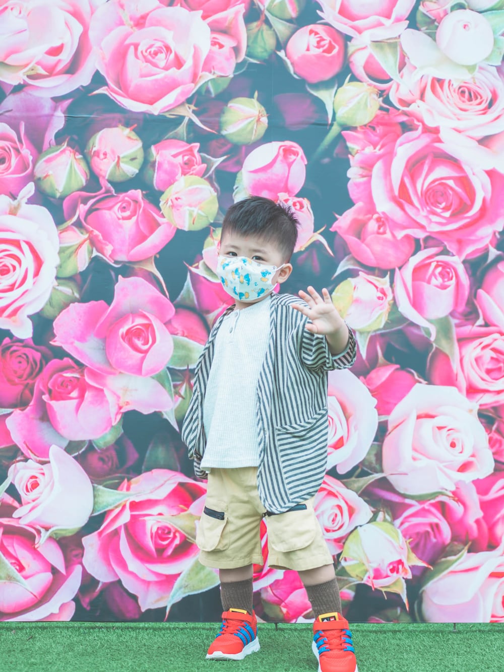 レッド系のスニーカー、ベージュ系のカーゴパンツを着用したキッズの春コーディネートの1枚目の写真