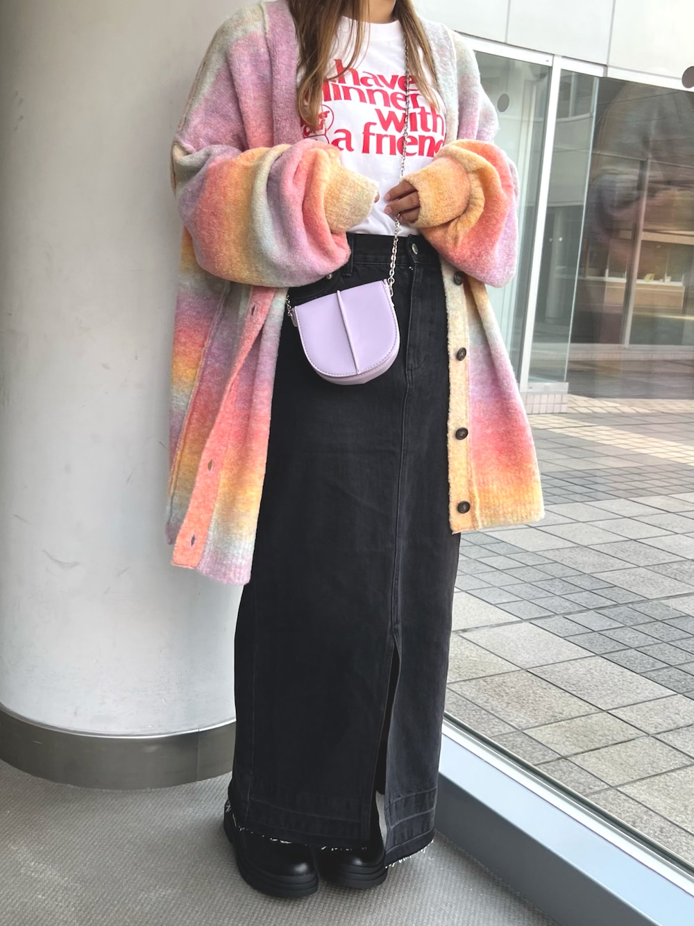 グレー系のデニムスカート、ピンク系のショルダーバッグ、ピンク系のカーディガン/ボレロを着用したレディースの夏コーディネートの1枚目の写真