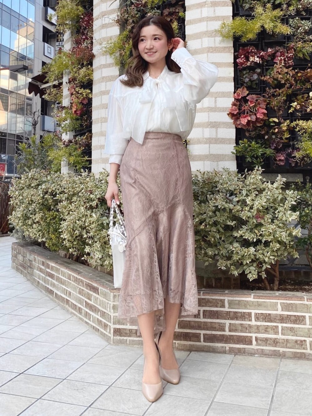 ホワイト系のシャツ/ブラウス、ブラウン系のスカートを着用したレディースの冬コーディネートの1枚目の写真