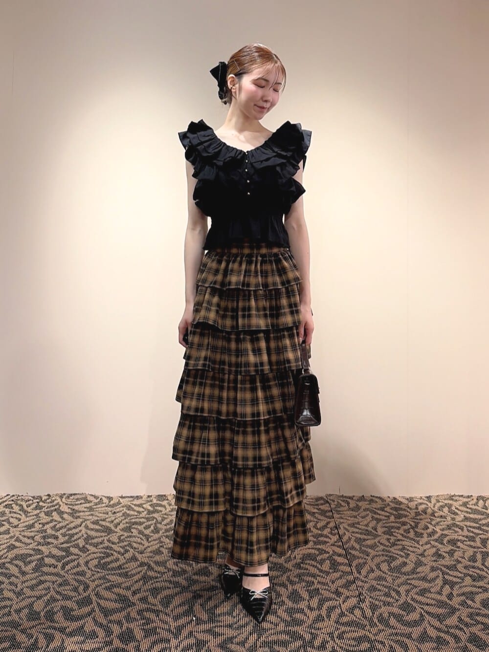 ブラック系のシャツ/ブラウス、イエロー系のスカート、ブラック系のバレッタ/ヘアクリップを着用したレディースの夏コーディネートの1枚目の写真