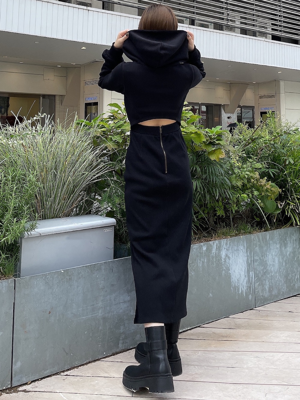 ブラック系のワンピース、ブラック系のブーツを着用したレディースの秋コーディネートの1枚目の写真