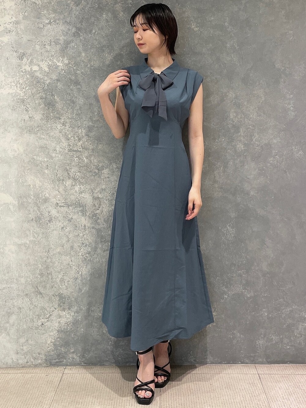 ブルー系のワンピース、ブラック系のサンダルを着用したレディースの夏コーディネートの1枚目の写真