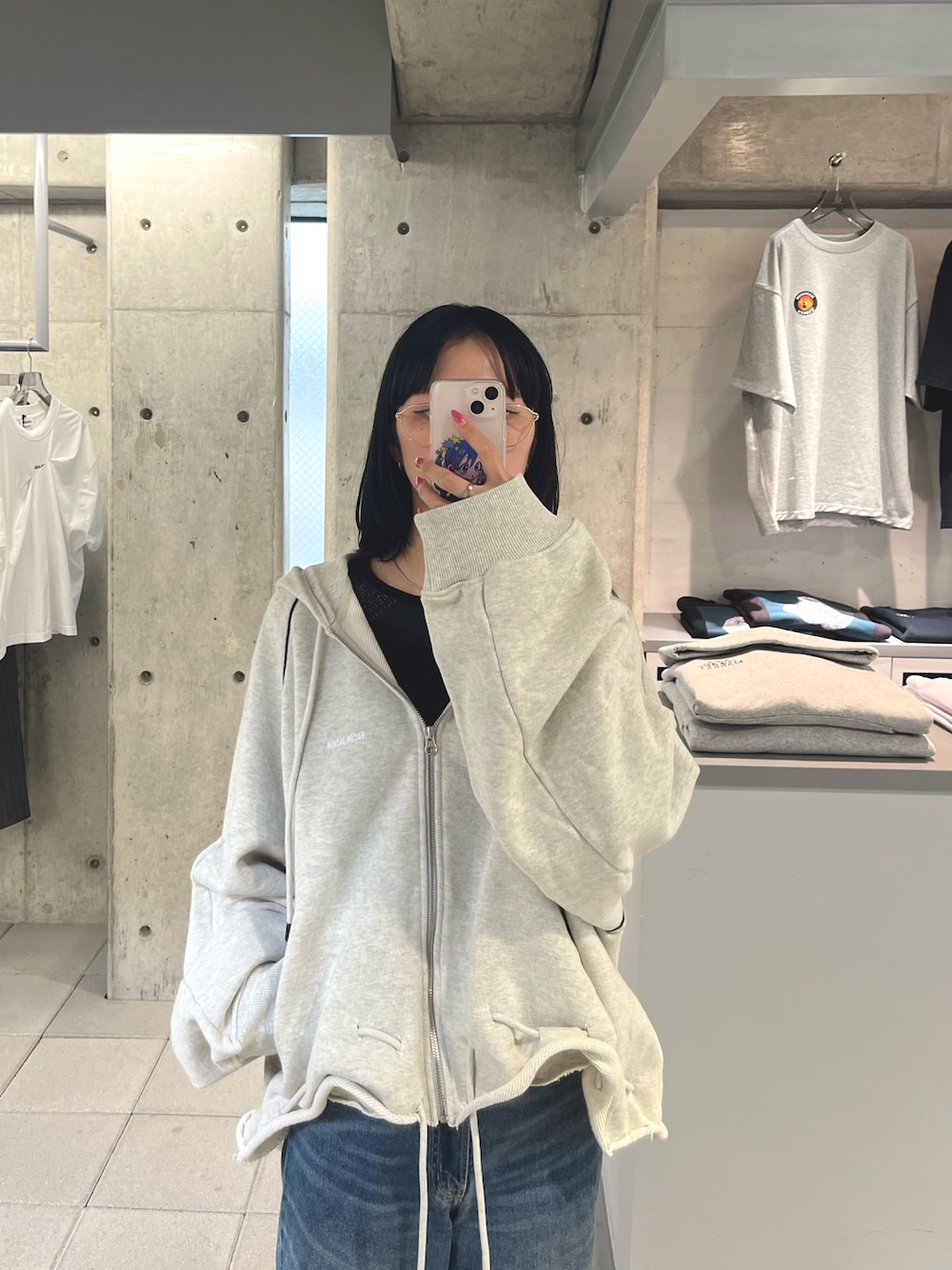 グレー系のパーカーを着用したレディースの夏コーディネートの1枚目の写真