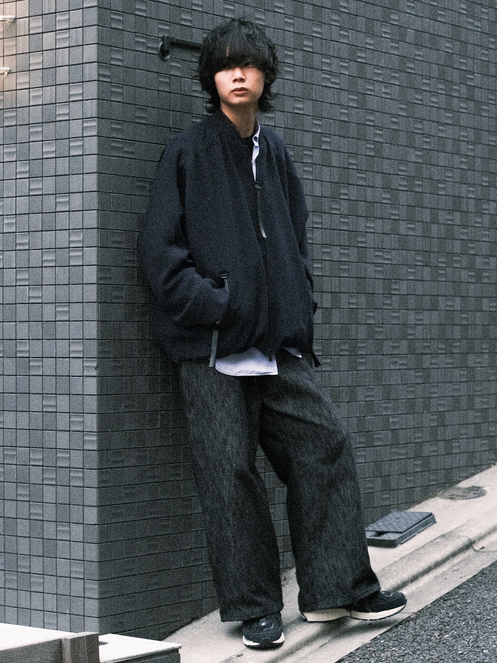 ブルー系のブルゾン、ブラック系のデニムパンツ、ブラック系のスニーカーを着用したメンズの春コーディネートの1枚目の写真