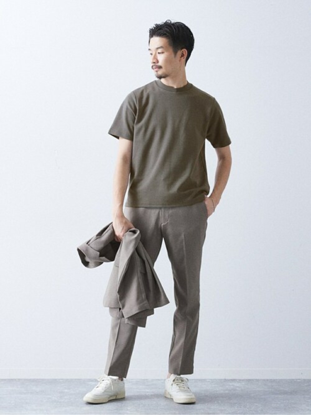 グレー系のTシャツ/カットソー、グリーン系のセットアップ、ホワイト系のスニーカーを着用したメンズの春コーディネートの1枚目の写真