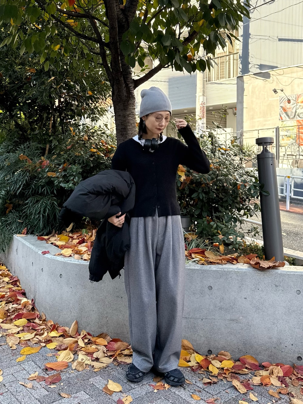 ブラック系のカーディガン/ボレロ、グレー系のスラックス、グレー系のニットキャップ/ビーニーを着用したレディースの秋コーディネートの1枚目の写真