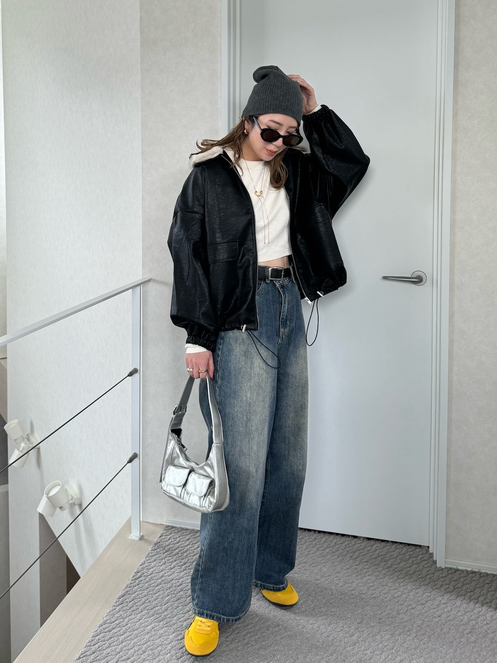 ブラック系のブルゾン、ホワイト系のTシャツ/カットソー、イエロー系のスニーカーを着用したレディースの秋コーディネートの1枚目の写真