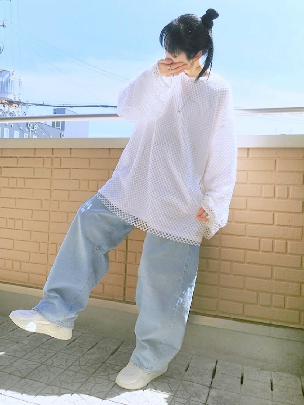 ホワイト系のスニーカー、ブルー系のデニムパンツ、ホワイト系のTシャツ/カットソーを着用したレディースの春コーディネートの1枚目の写真