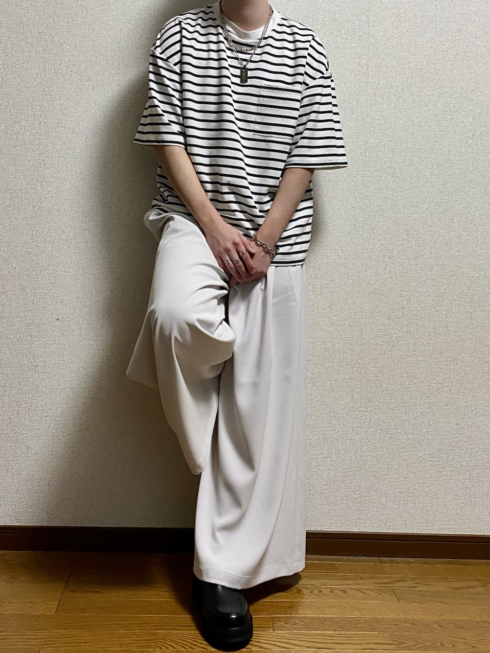 ホワイト系のTシャツ/カットソー、ホワイト系のスラックス、ブラック系のドレスシューズを着用したメンズの春コーディネートの1枚目の写真