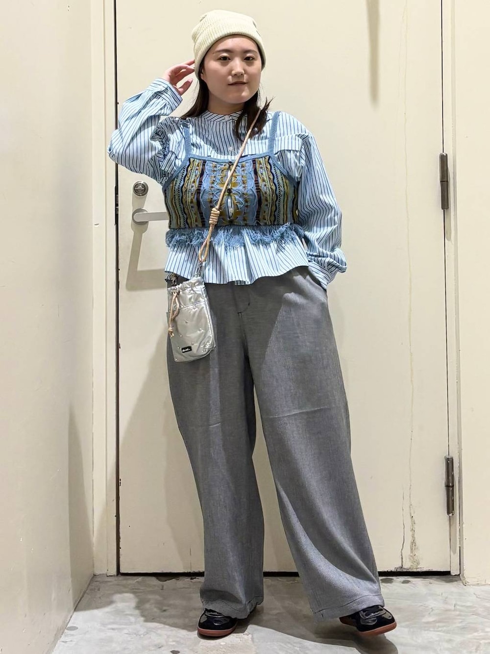 シルバー系のショルダーバッグ、グレー系のその他パンツ、シルバー系のスニーカーを着用したレディースの春コーディネートの1枚目の写真