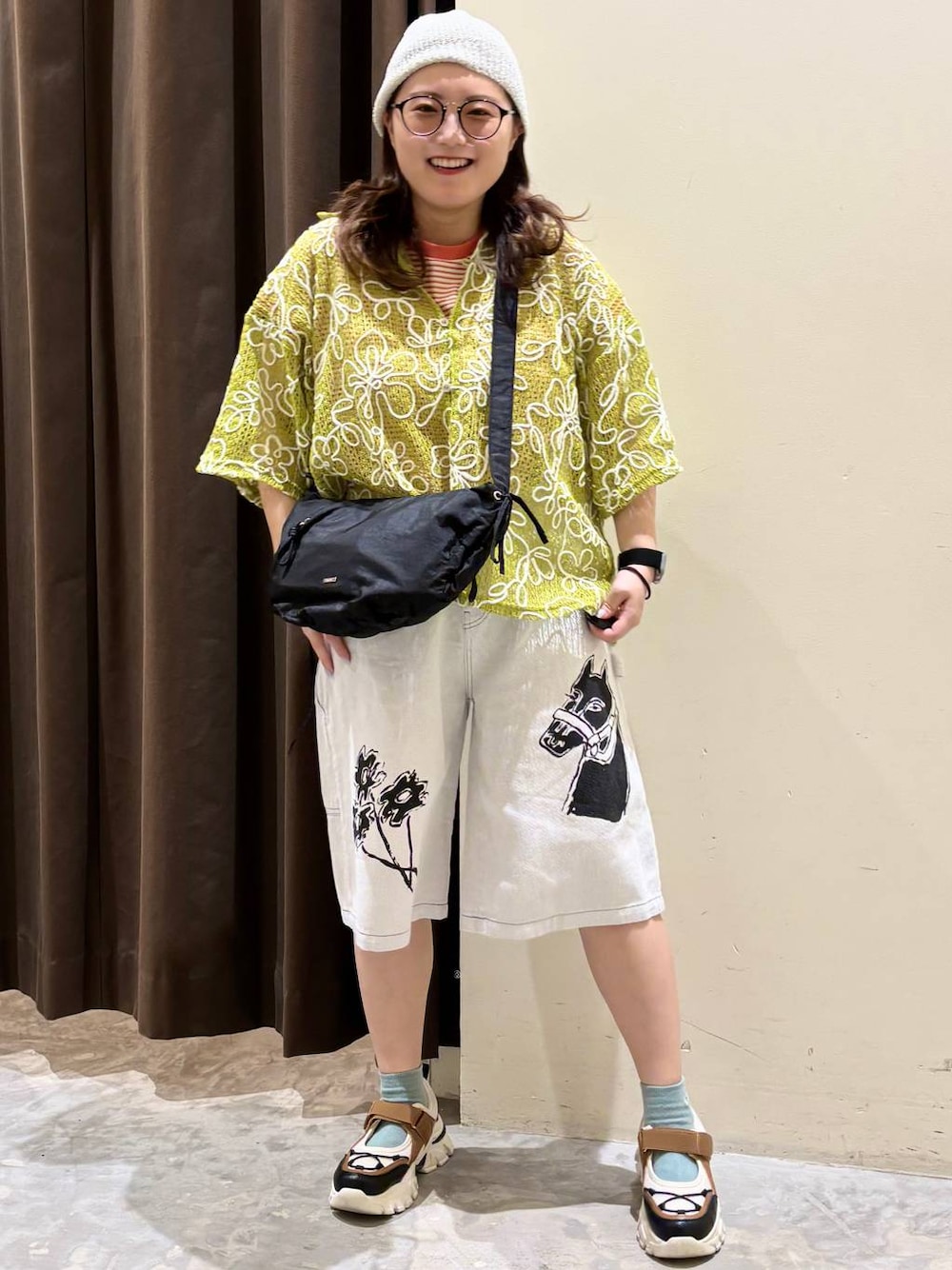 ブラック系のショルダーバッグ、オレンジ系のTシャツ/カットソー、その他のスニーカーを着用したレディースの春コーディネートの1枚目の写真